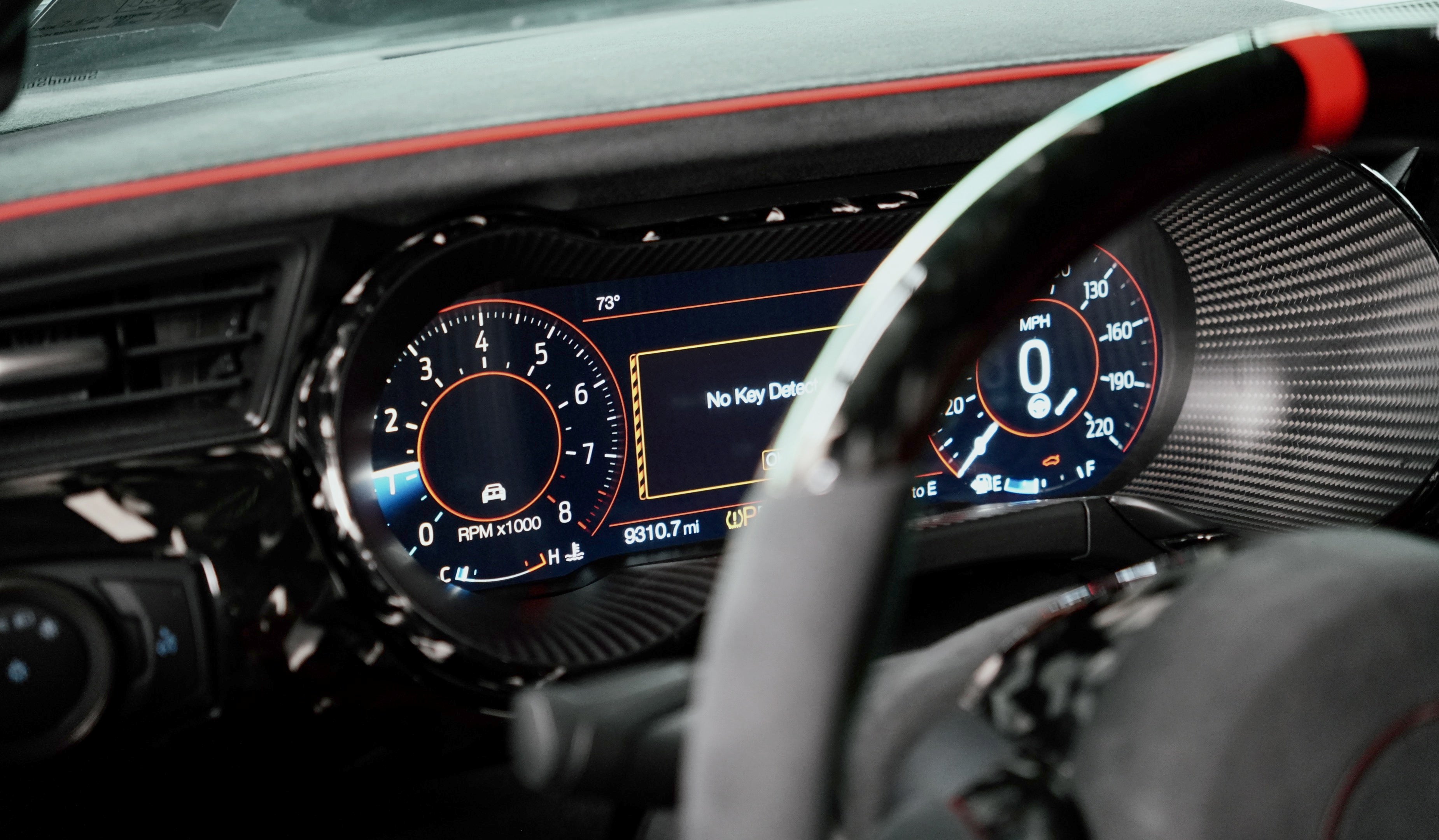 Mustang digital speedometer cluster with carbon fiber navigation bezel and speedo tunnel surround installed