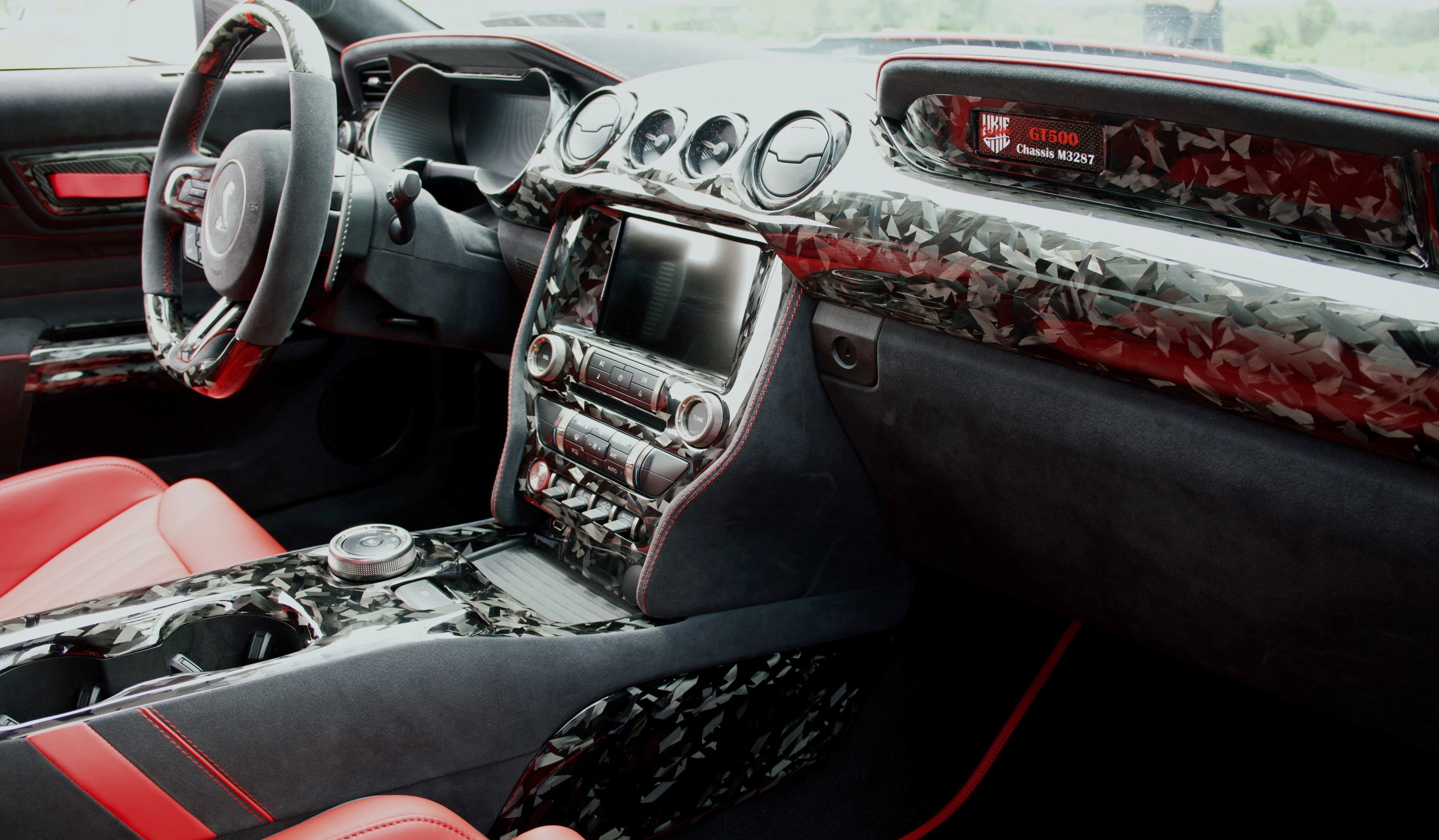 Ford Mustang S550 custom interior with forged carbon fiber dash and console trim, matte 2x2 twill gauge cluster hood, Alcantara and leather upholstery by UkieCarbon.