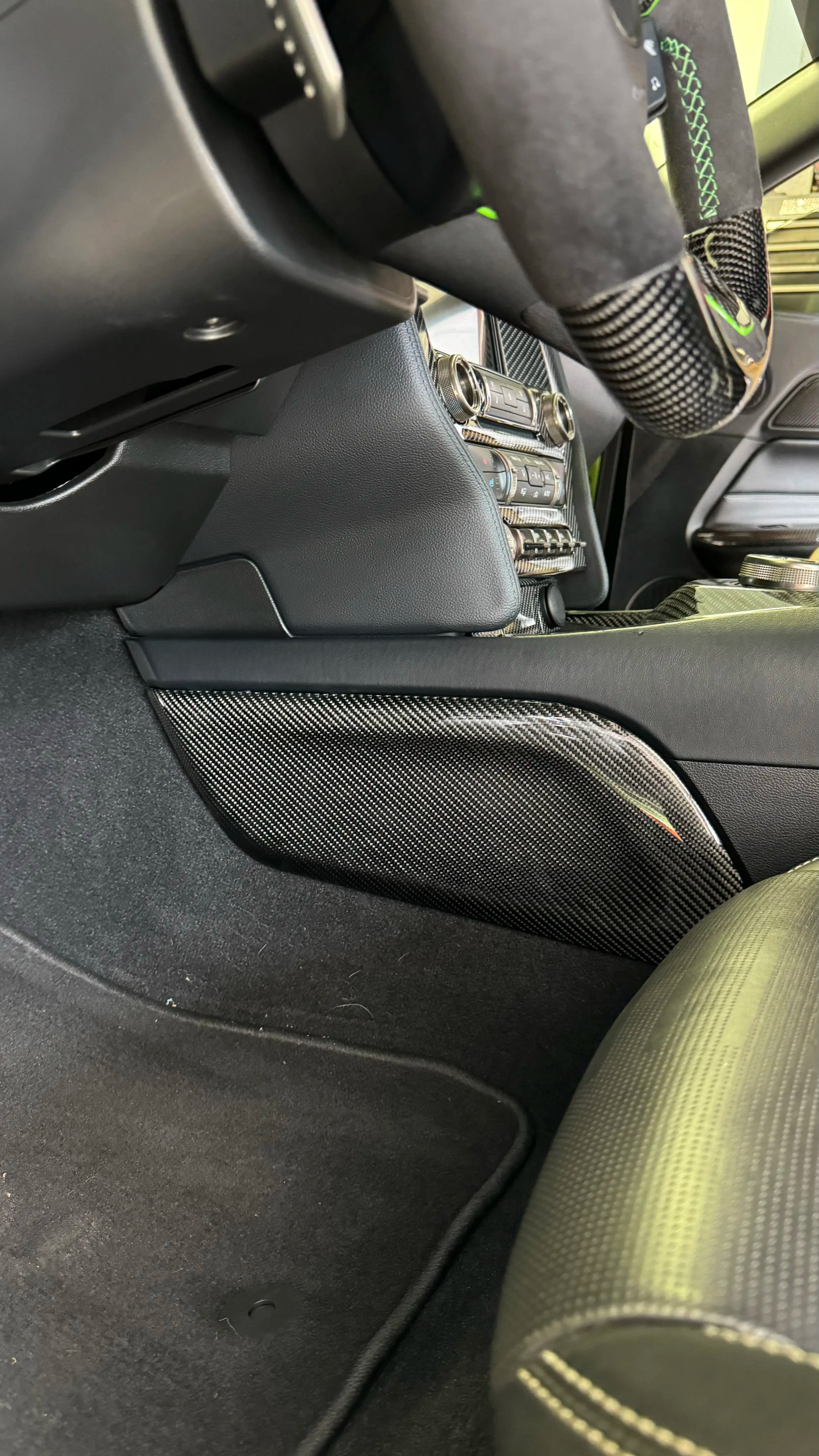 Mustang interior knee pad with carbon fiber lower console panel trim installed
