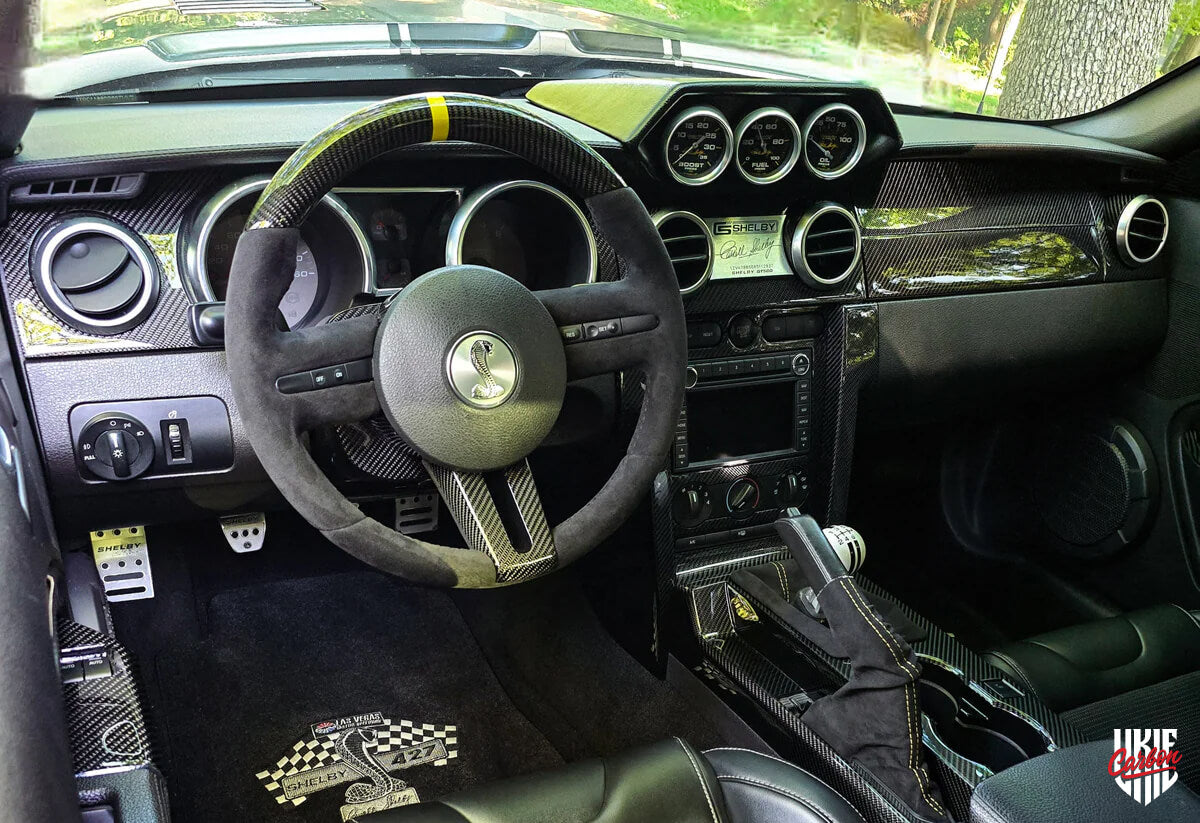 Mustang S197 interior with carbon fiber trims and custom gloss carbon fiber steering wheel, alcantara and yellow stripe